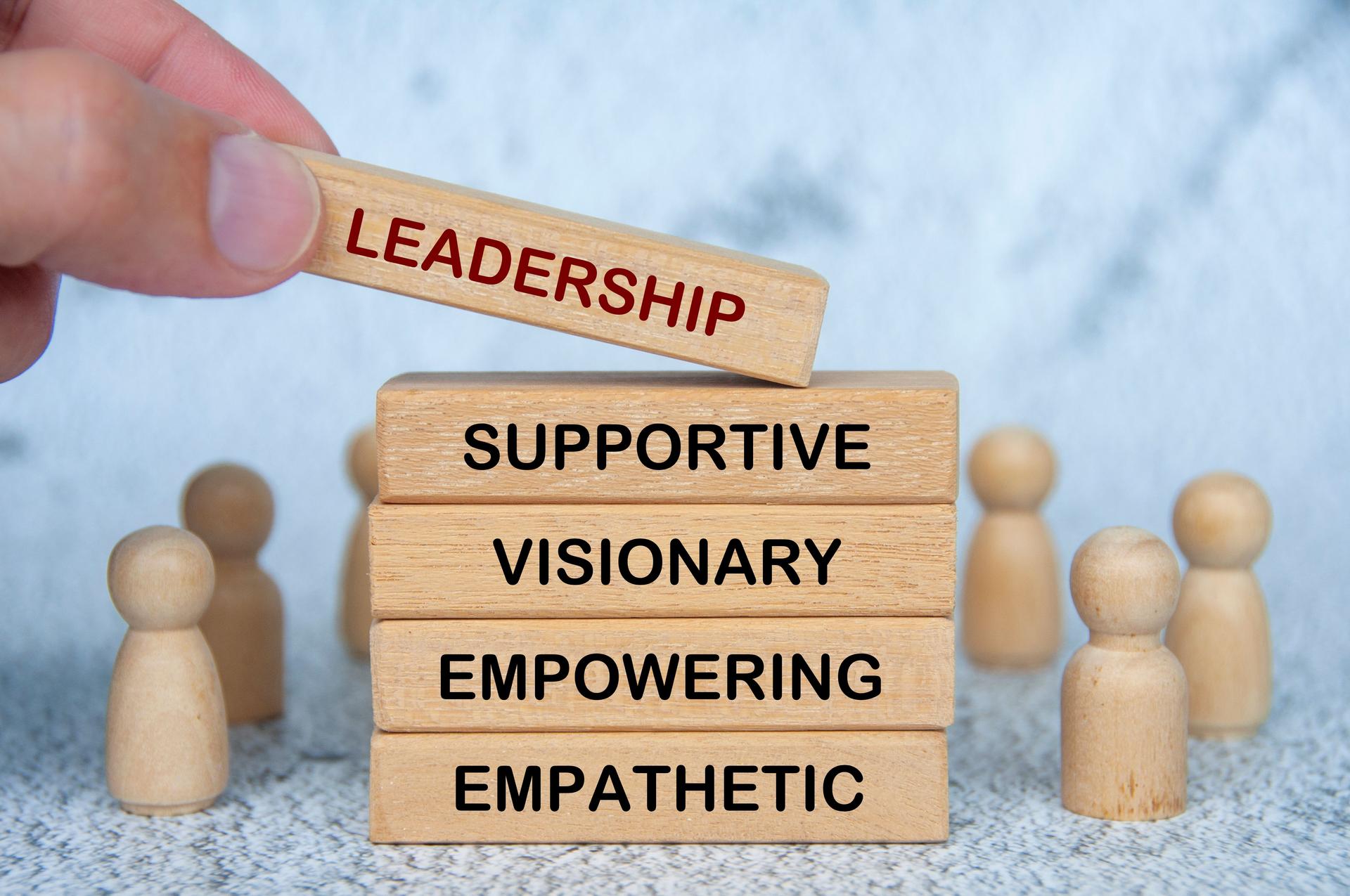 LEADERSHIP, SUPPORTIVE, VISIONARY, EMPOWERING and EMPATHETIC text on wooden blocks. Leadership concept.